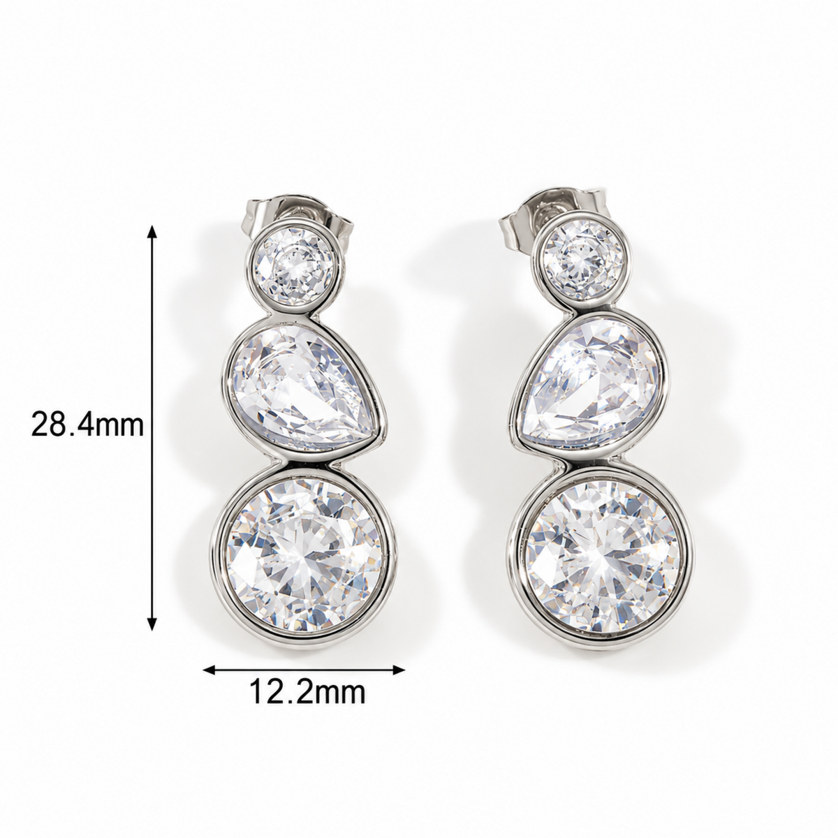 A pair of silver-tone drop earrings with three clear round-cut stones stacked vertically, shown on a white background with dimension markers indicating 28.4mm height and 12.