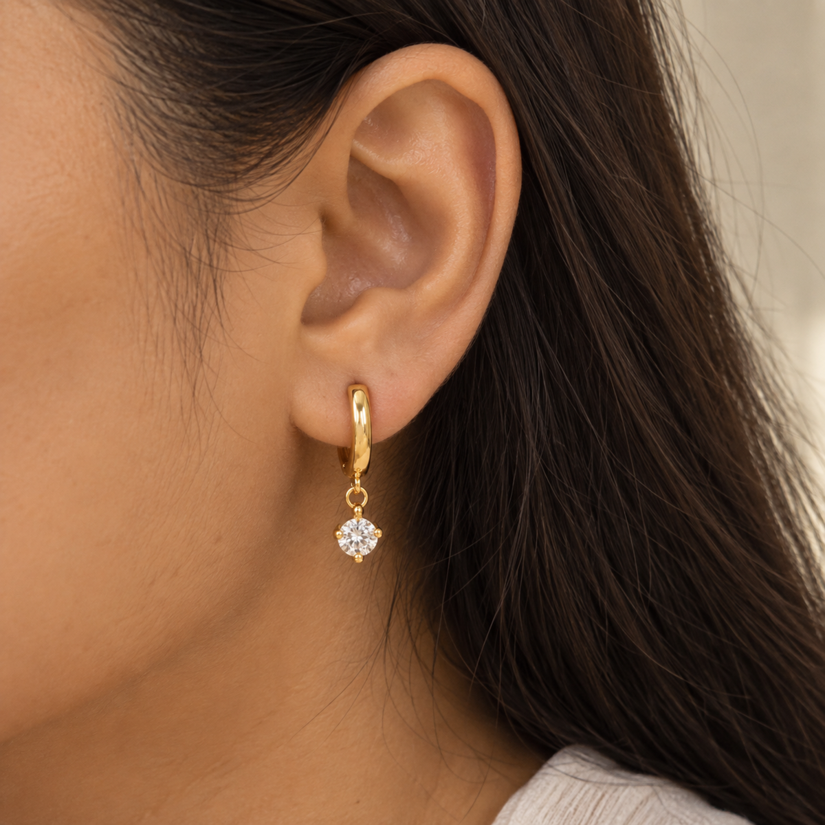 Elise gold crystal drop hoop earrings for women with 18kt gold plated hoops and sparkling round crystal accents on a model