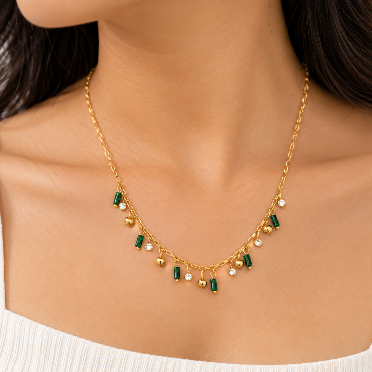 Green Charm Necklace with green cylindrical charms, clear crystal accents and gold-tone ball charms on a model
