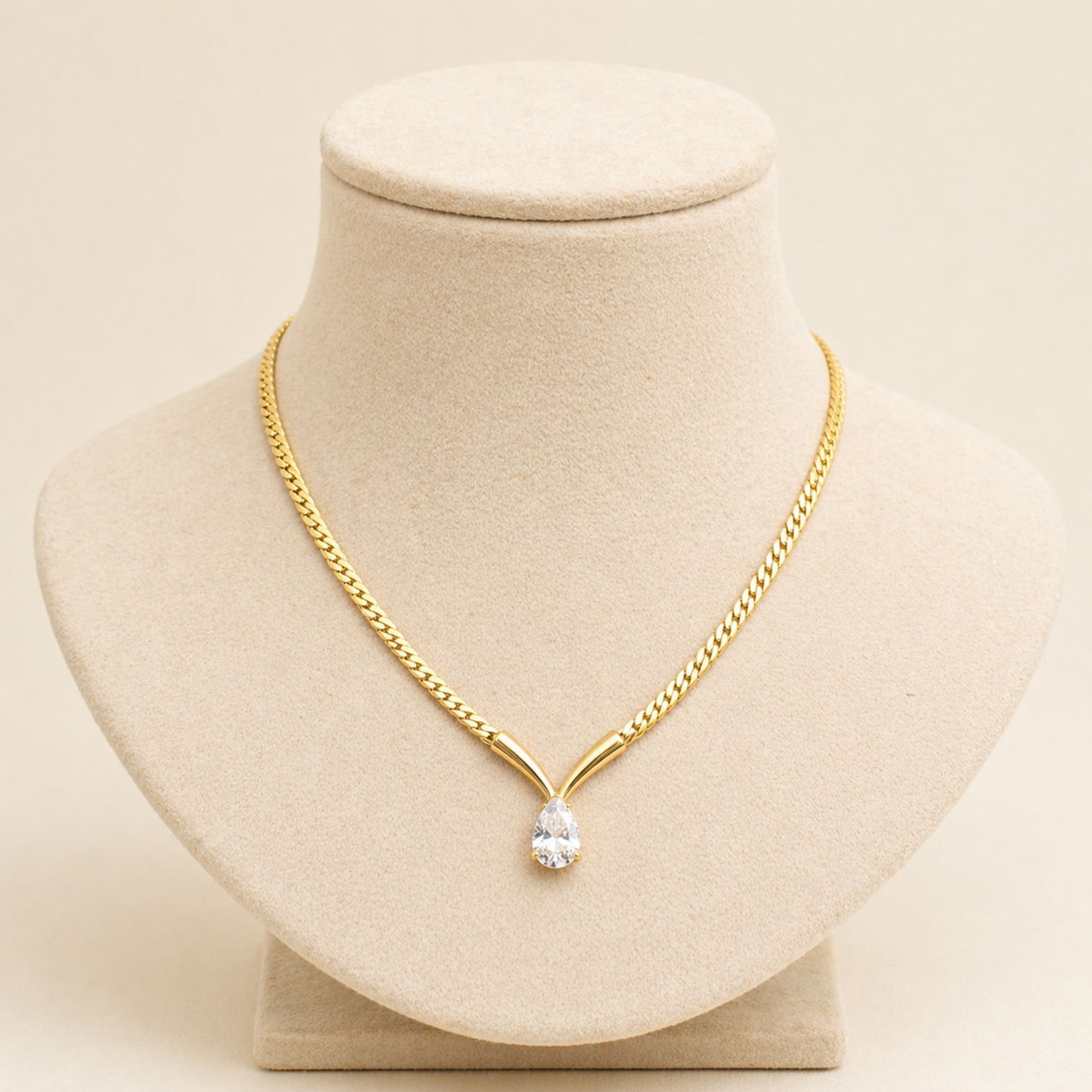 A gold-plated stainless steel chain for women featuring a V-shaped mounting and a large sparkling teardrop crystal pendant