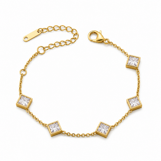 A gold-plated ladies bracelet featuring a fine chain and five strategically spaced square-cut princess crystals in bezel settings.