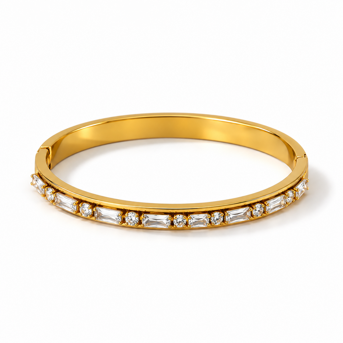 A yellow gold hinged bangle bracelet featuring a row of clear baguette and round-cut gemstones along the front edge, set against a clean white background.