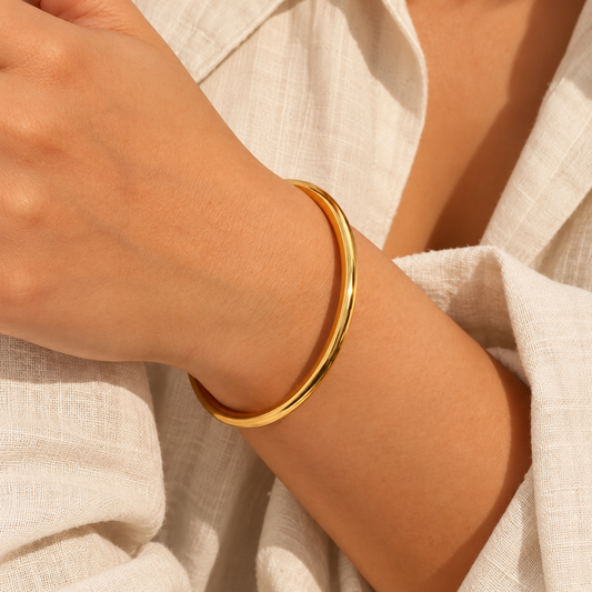 Minimal Gold Bangle Bracelet with a smooth, rounded band and polished gold-plated finish, on a model