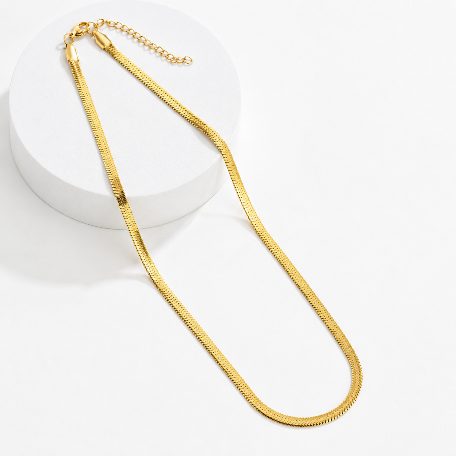 A gold-plated stainless steel chain for women featuring a high-shine, liquid-like flat snake chain layout.