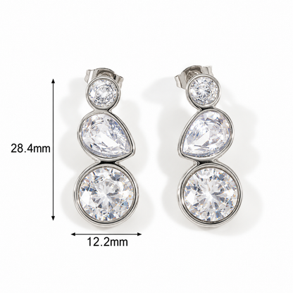 A pair of silver-tone drop earrings with three clear round-cut stones stacked vertically, shown on a white background with dimension markers indicating 28.4mm height and 12.