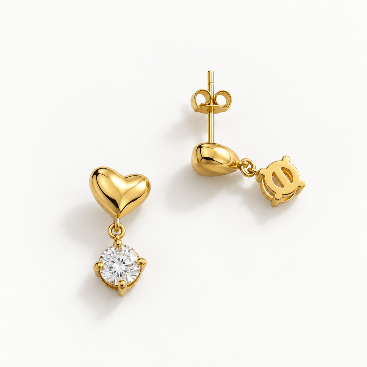 A side view of Alina gold heart drop earrings for women with sparkling round crystal stones and pvd gold plated
