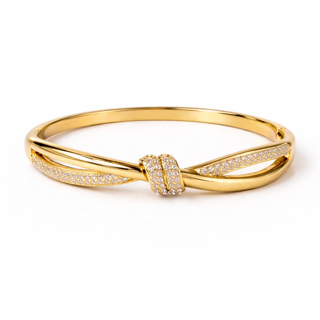 A high-end gold-plated knot bangle for women featuring a sparkling white stones central knot and a double-band cross-over design on a white background