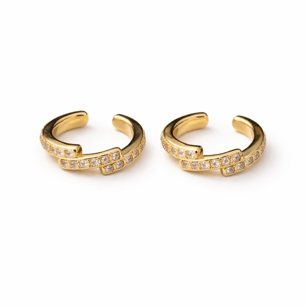 A pair of gold-plated ear cuff for women featuring one smooth polished band and one crystal-encrusted pavé band
