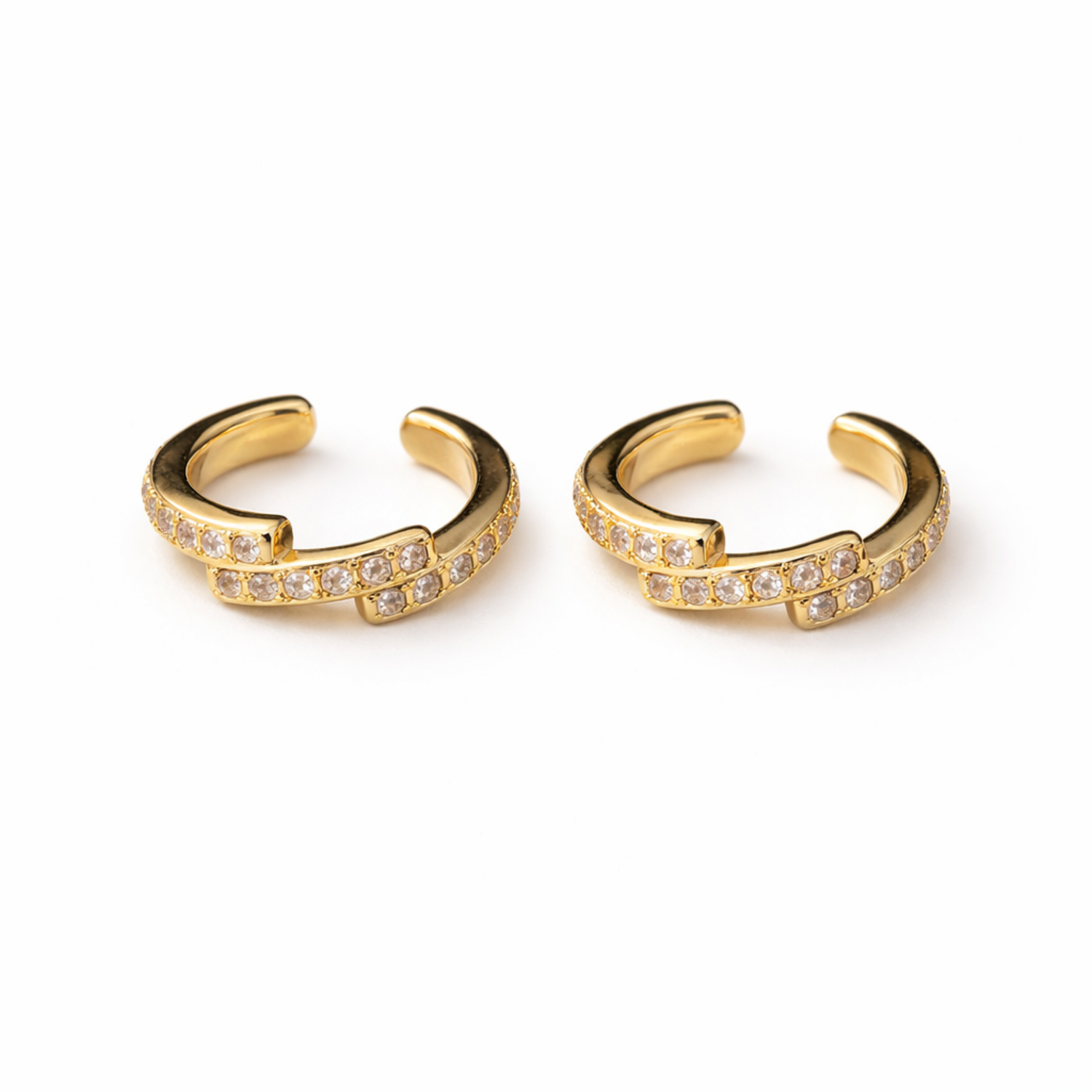 A pair of gold-plated ear cuff for women featuring one smooth polished band and one crystal-encrusted pavé band