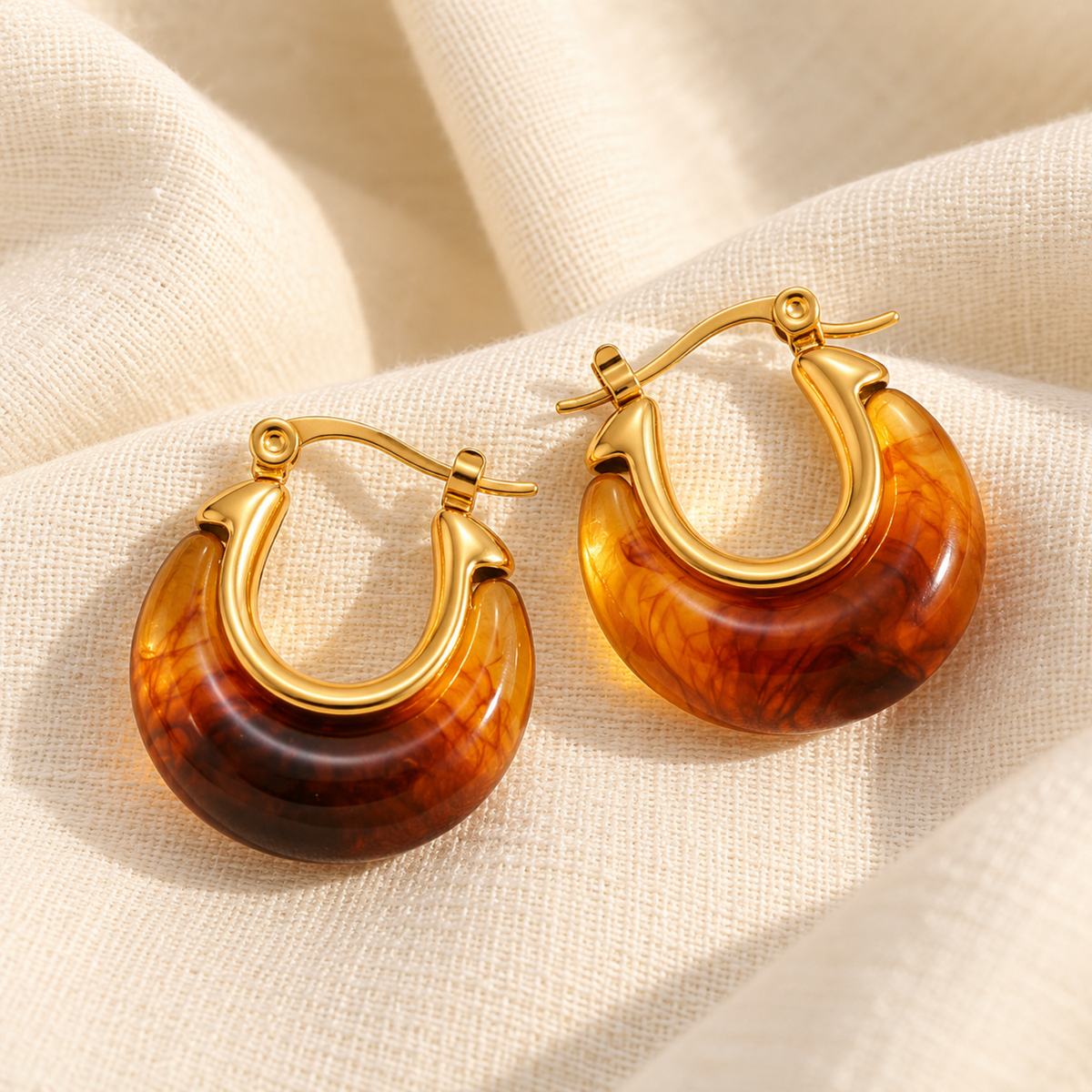 Amber resin hoop earrings for women with 18K gold plated accents, chunky rounded design and glossy finish