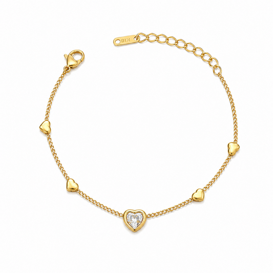 A gold-plated ladies bracelet featuring a central crystal heart and four small polished gold heart accents on a fine chain.