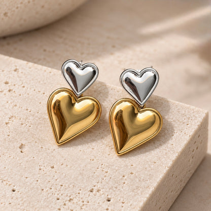 Two-tone heart earrings for women featuring layered polished gold and silver heart shapes