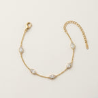 A dainty gold-plated chain bracelet for women featuring clear marquise-cut stone stations, shown on a clean off-white background