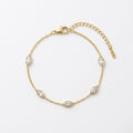 A dainty gold-plated chain bracelet for women featuring clear marquise-cut stone stations, shown on a clear white background