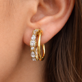 A gold-plated double-strand open hoop earrings for women featuring sparkling marquise and round-cut crystals, shown on a model