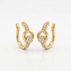 A pair of gold-plated ear cuffs for women featuring five brilliant-cut stones, shown on a white surface