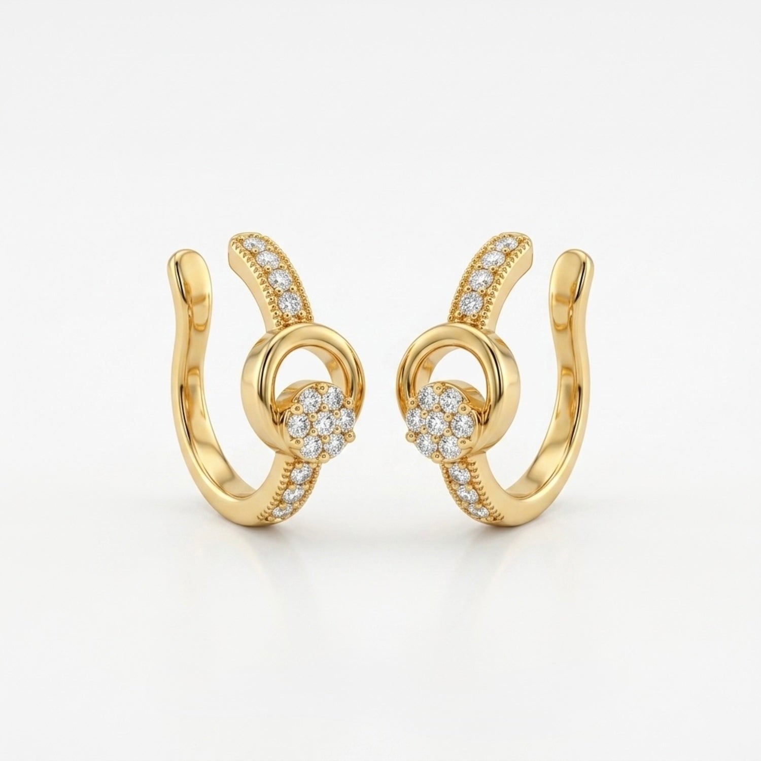 A pair of gold-plated ear cuffs for women featuring five brilliant-cut stones, shown on a white surface