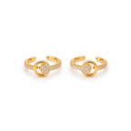 A pair of gold-plated ear cuffs for women featuring five brilliant-cut stones, shown on a textured white surface.