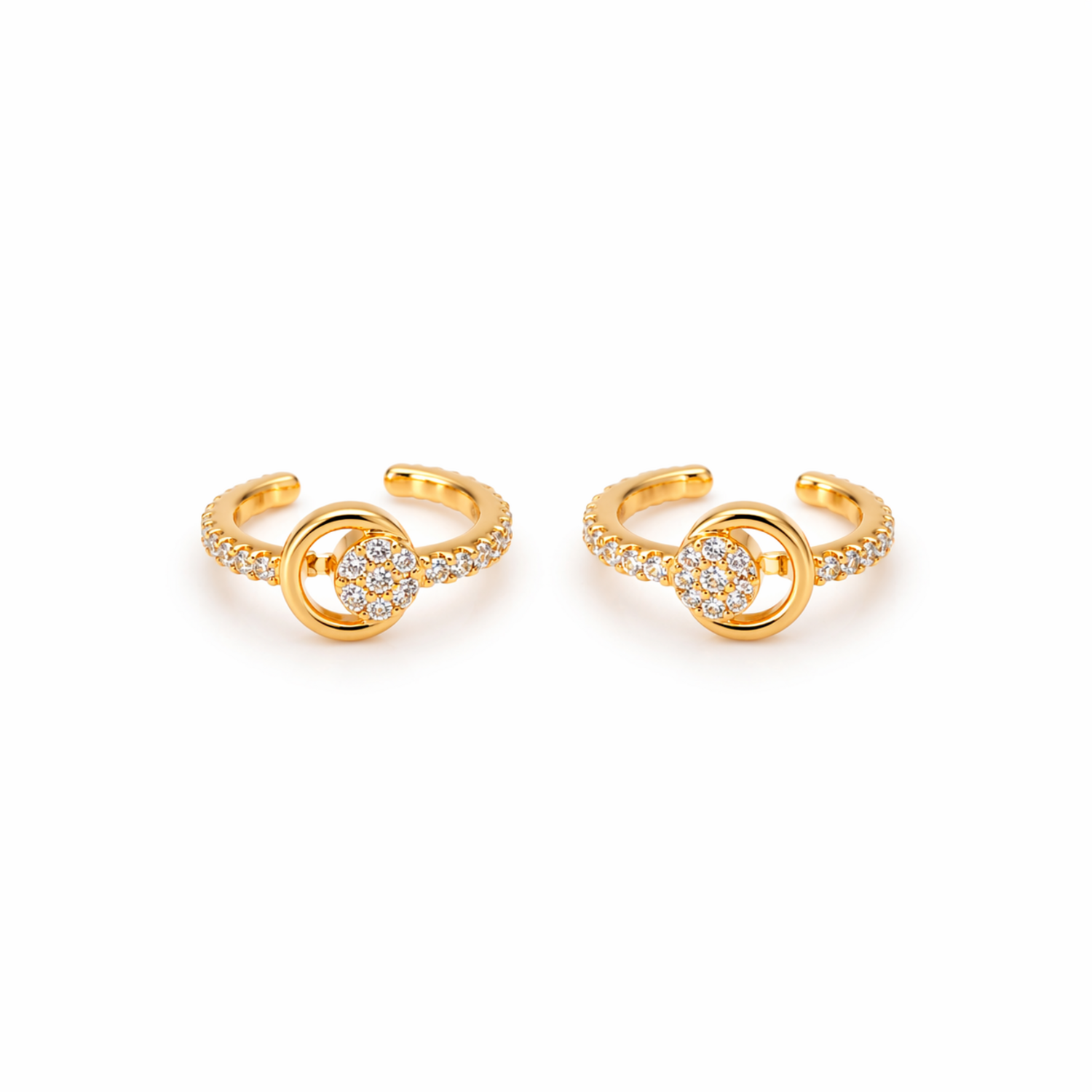 A pair of gold-plated ear cuffs for women featuring five brilliant-cut stones, shown on a textured white surface.