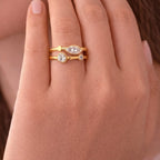 A close view of gold plated adjustable ring for women with a double-band design featuring a central marquise-cut white stone
