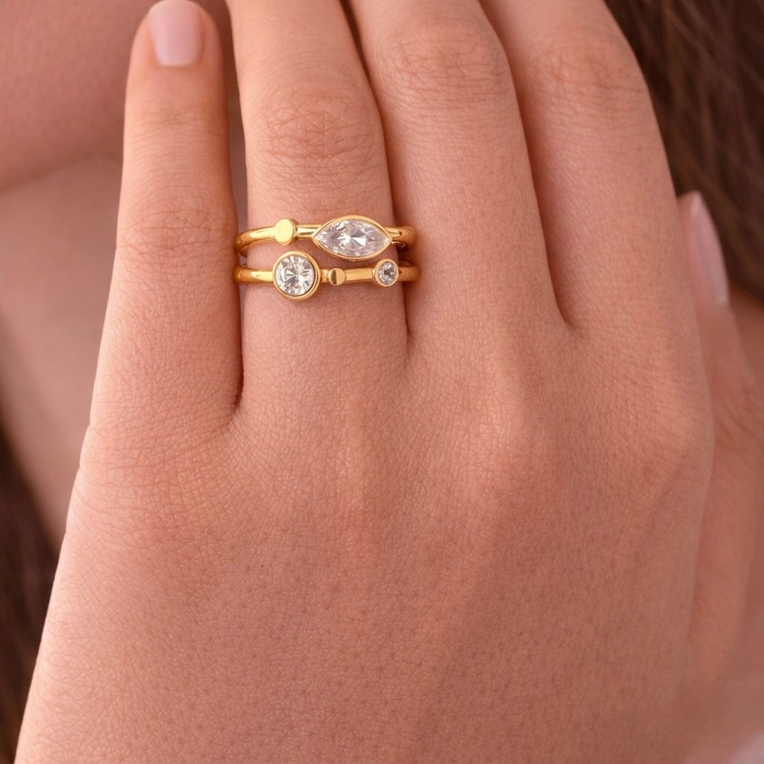 A close view of gold plated adjustable ring for women with a double-band design featuring a central marquise-cut white stone