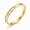 A gold-plated dual-band cuff bangle for women featuring crystal pillars and a secure side-hinge clasp.