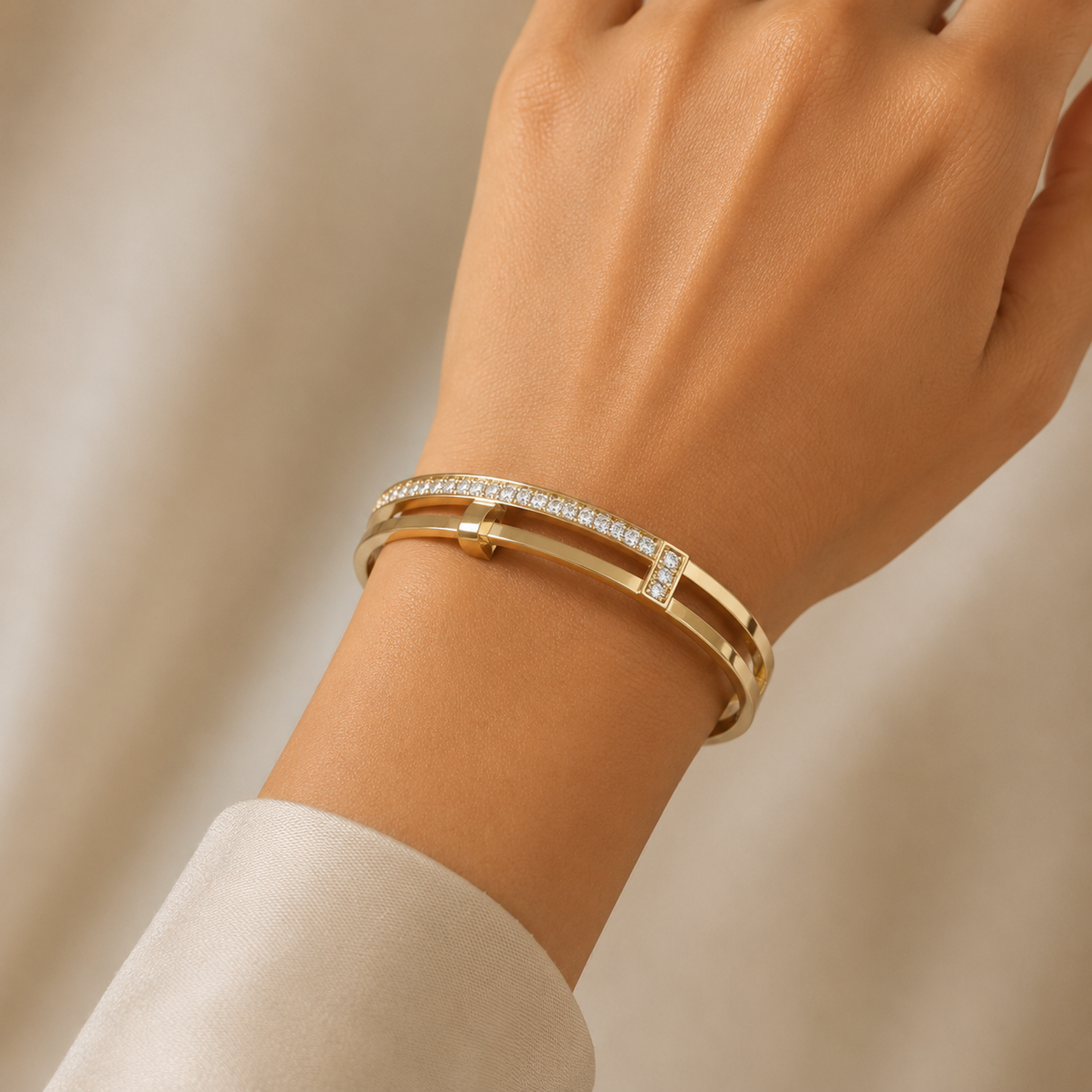 A gold-plated dual-band cuff bangle for women featuring crystal pillars and a secure side-hinge clasp, shown on a model