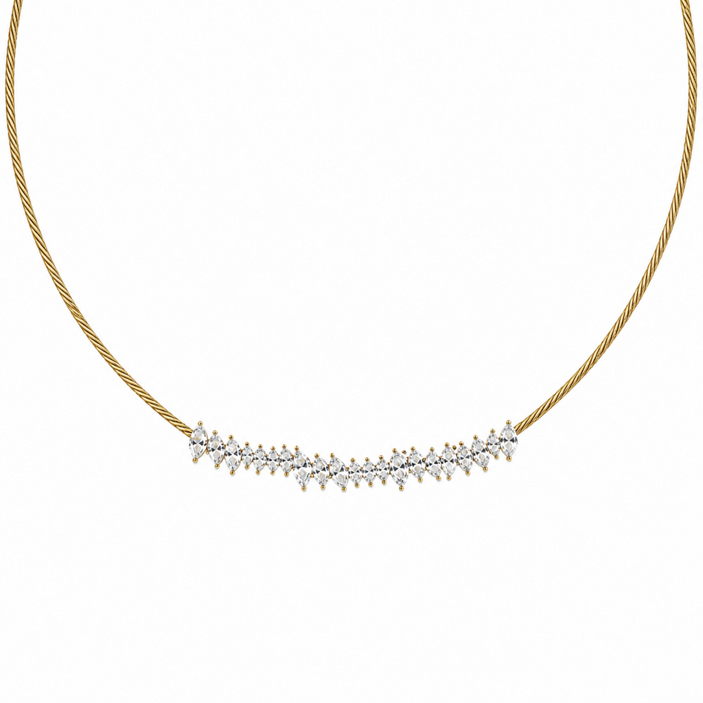 A close-view of a gold-plated stainless steel chain for women featuring a twisted cable design and an asymmetrical cluster of marquise-cut crystals