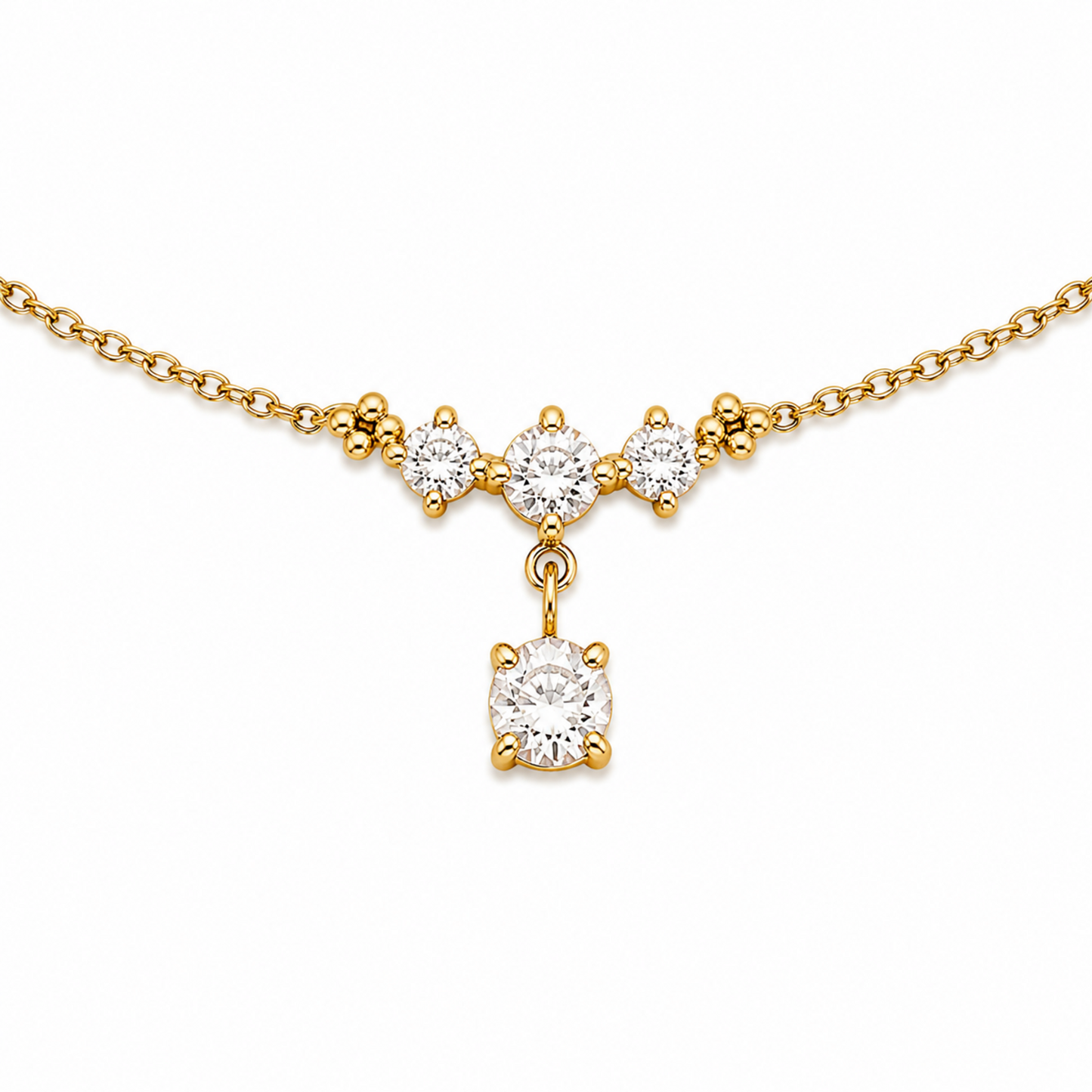 A close-view of a delicate gold-plated ladies bracelet featuring a cluster of four brilliant-cut crystals and a dangling drop stone.