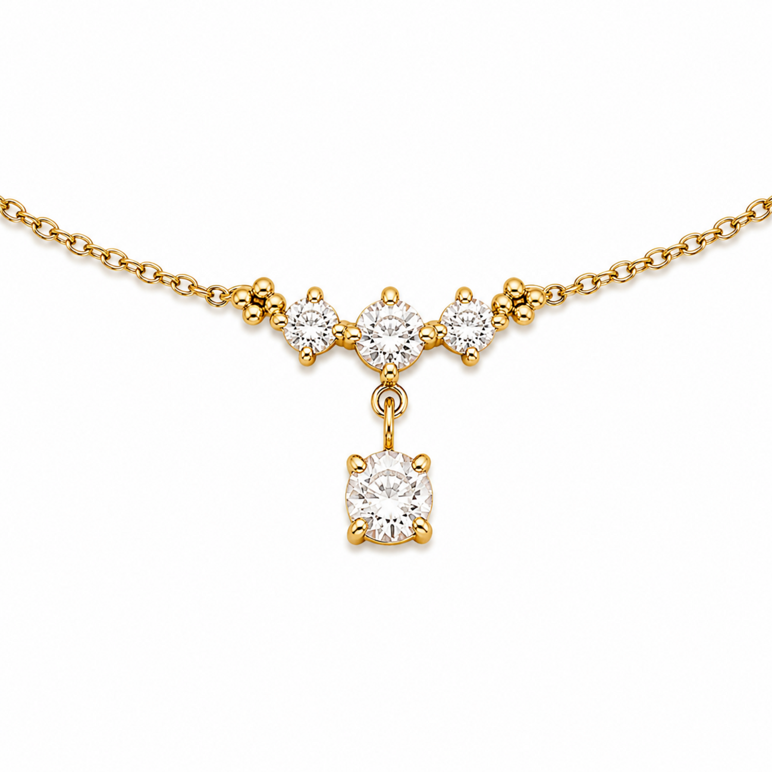 A close-view of a delicate gold-plated ladies bracelet featuring a cluster of four brilliant-cut crystals and a dangling drop stone.