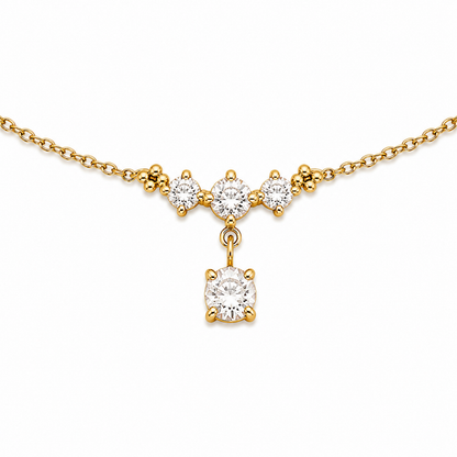 A close-view of a delicate gold-plated ladies bracelet featuring a cluster of four brilliant-cut crystals and a dangling drop stone.