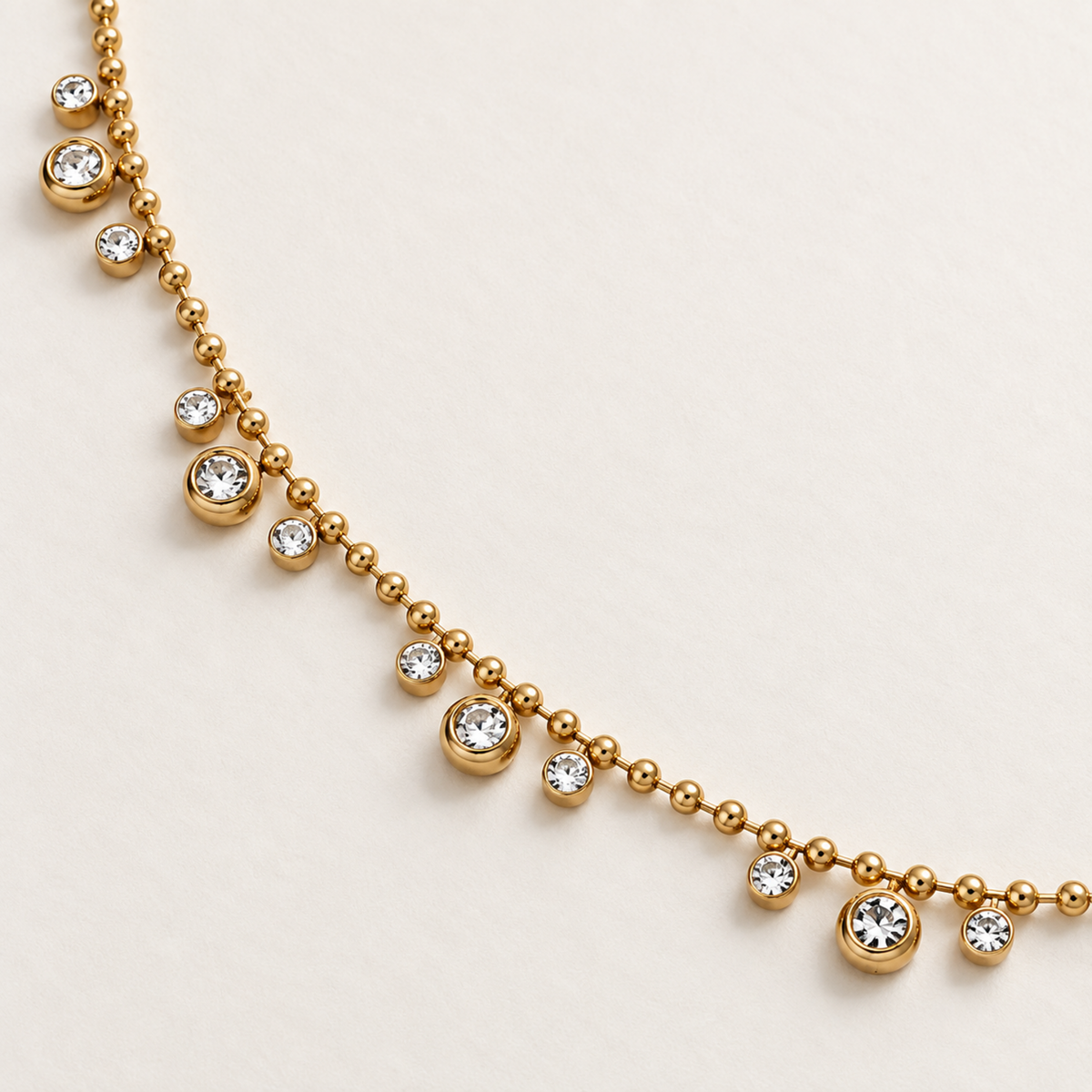 A close-view of Aveline gold crystal necklace for women with beaded chain and sparkling round crystal charms