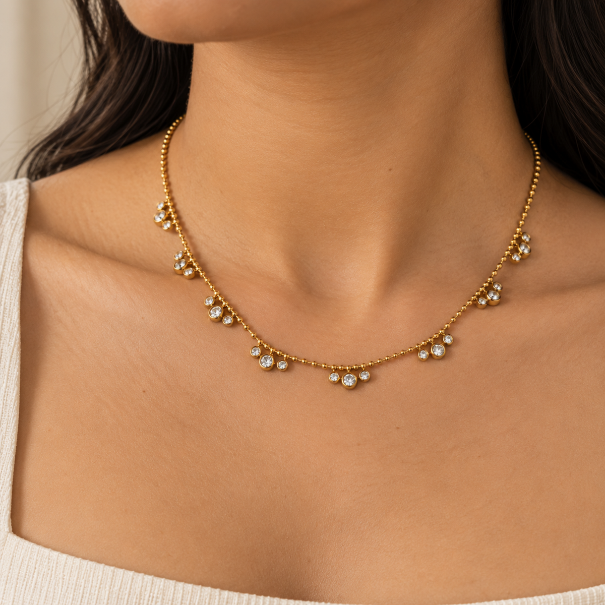 Aveline gold crystal necklace for women with beaded chain and sparkling round crystal charms on a model