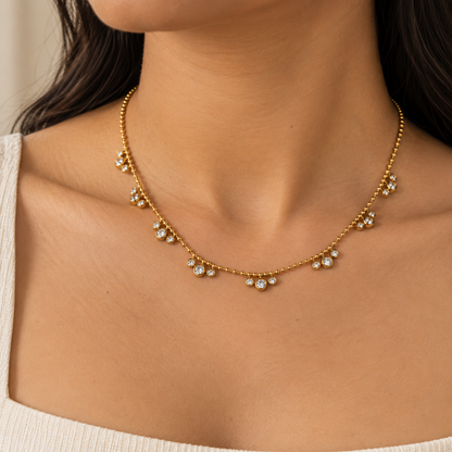 Aveline gold crystal necklace for women with beaded chain and sparkling round crystal charms on a model
