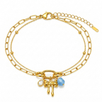 A gold-plated layered chain bracelet for women featuring a paperclip chain, a satellite chain, a gold bow charm, and a blue stone