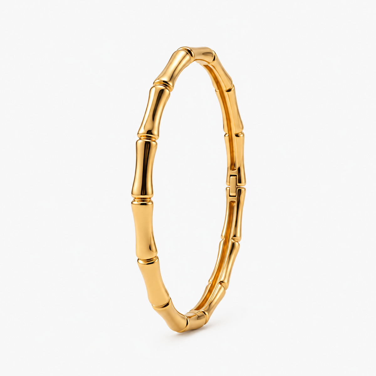 A close-view of a Bamboo Gold Bangle Bracelet with sculpted, segmented bamboo-inspired links and a gold-plated finish.