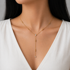 A gold-plated stainless steel chain for women in a Y-drop lariat style featuring delicate beads and crystal accents, shown on a model