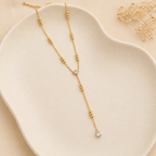 A gold-plated stainless steel chain for women in a Y-drop lariat style featuring delicate beads and crystal accents