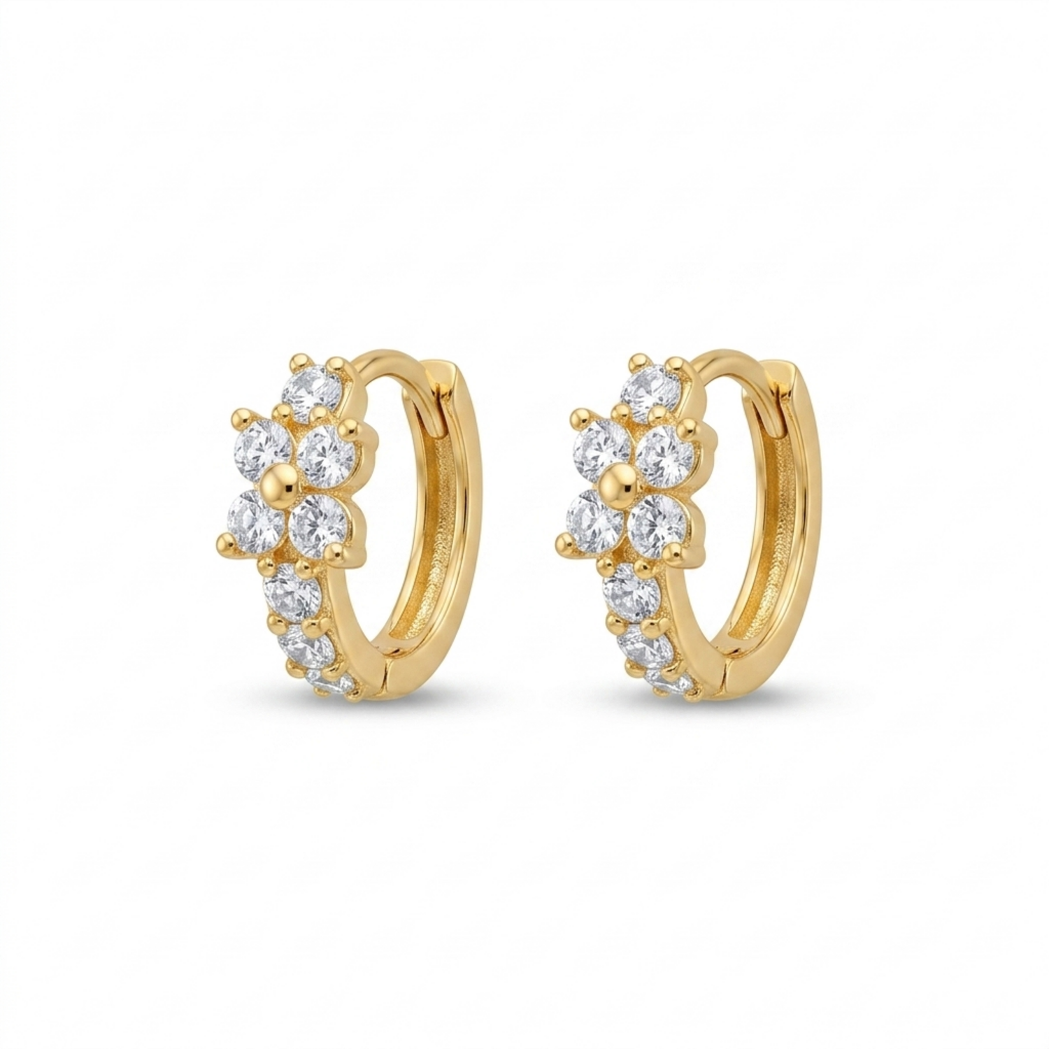 A pair of gold-plated huggie hoop earrings for women featuring a small clear crystal flower design, on a white background