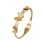 A gold-plated cuff bangle for women featuring three frosted-finish butterfly charms and polished circular links.
