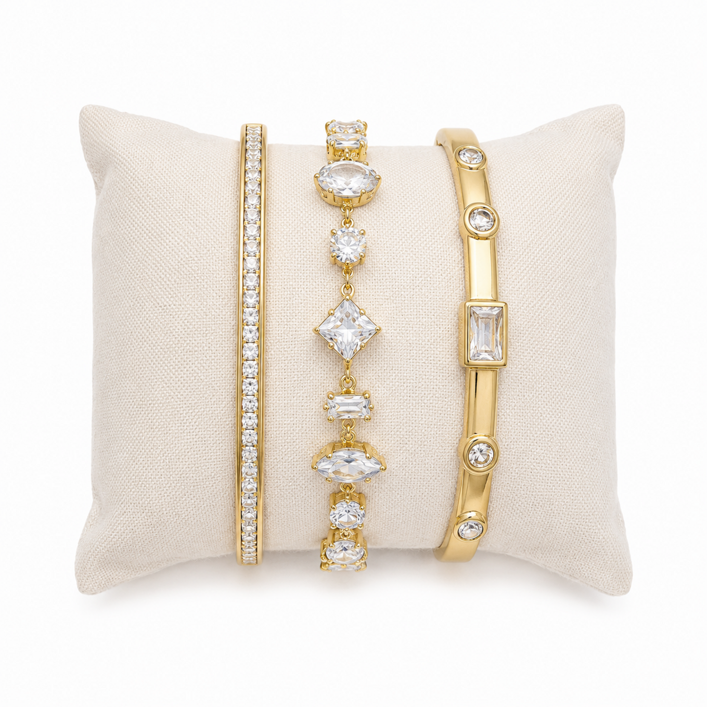 A three-piece gold-plated bracelet stack for women featuring an iced eternity bangle, a multi-cut geometric crystal chain bracelet, and a polished bezel-set crystal bangle