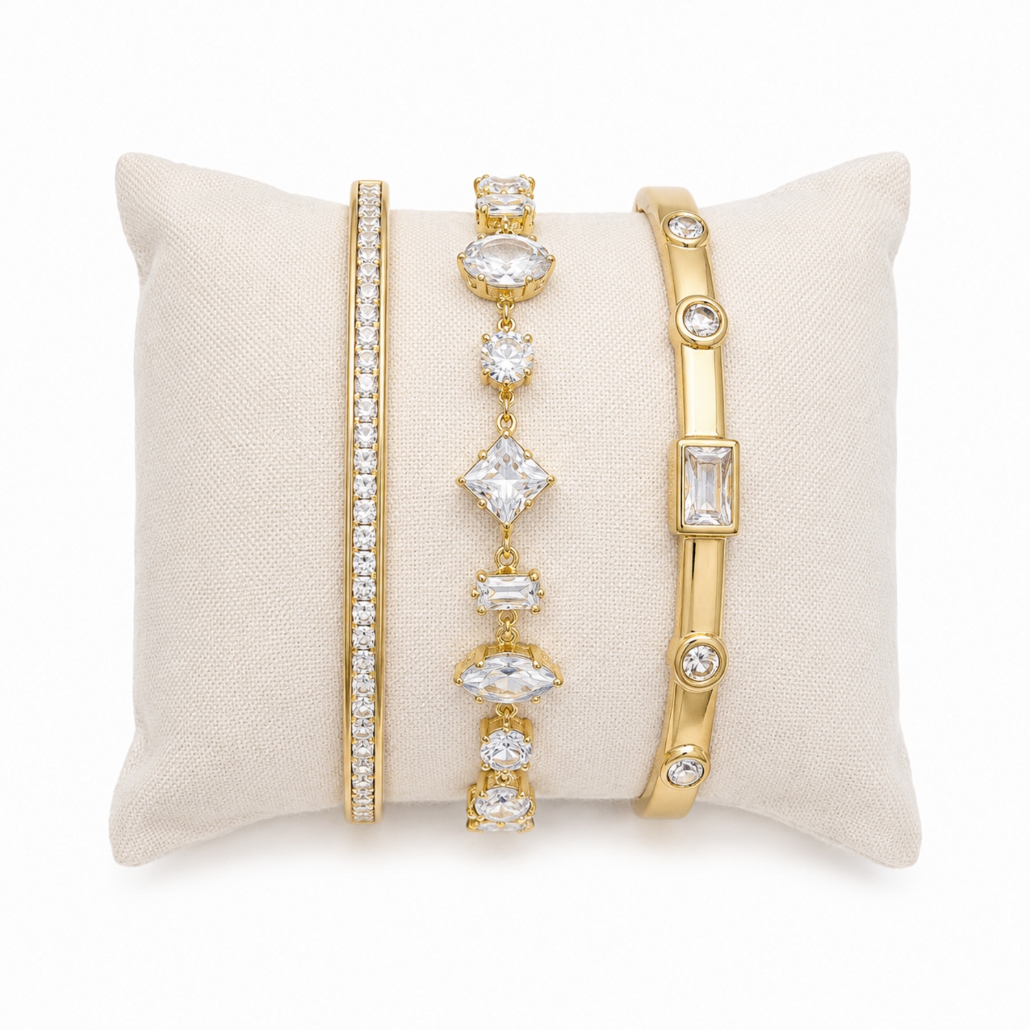 A three-piece gold-plated bracelet stack for women featuring an iced eternity bangle, a multi-cut geometric crystal chain bracelet, and a polished bezel-set crystal bangle