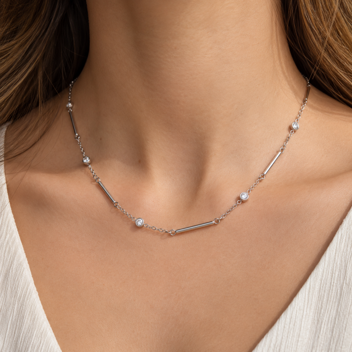 Silver crystal bar necklace for women with delicate chain, polished bar details and sparkling round crystal accents on a model