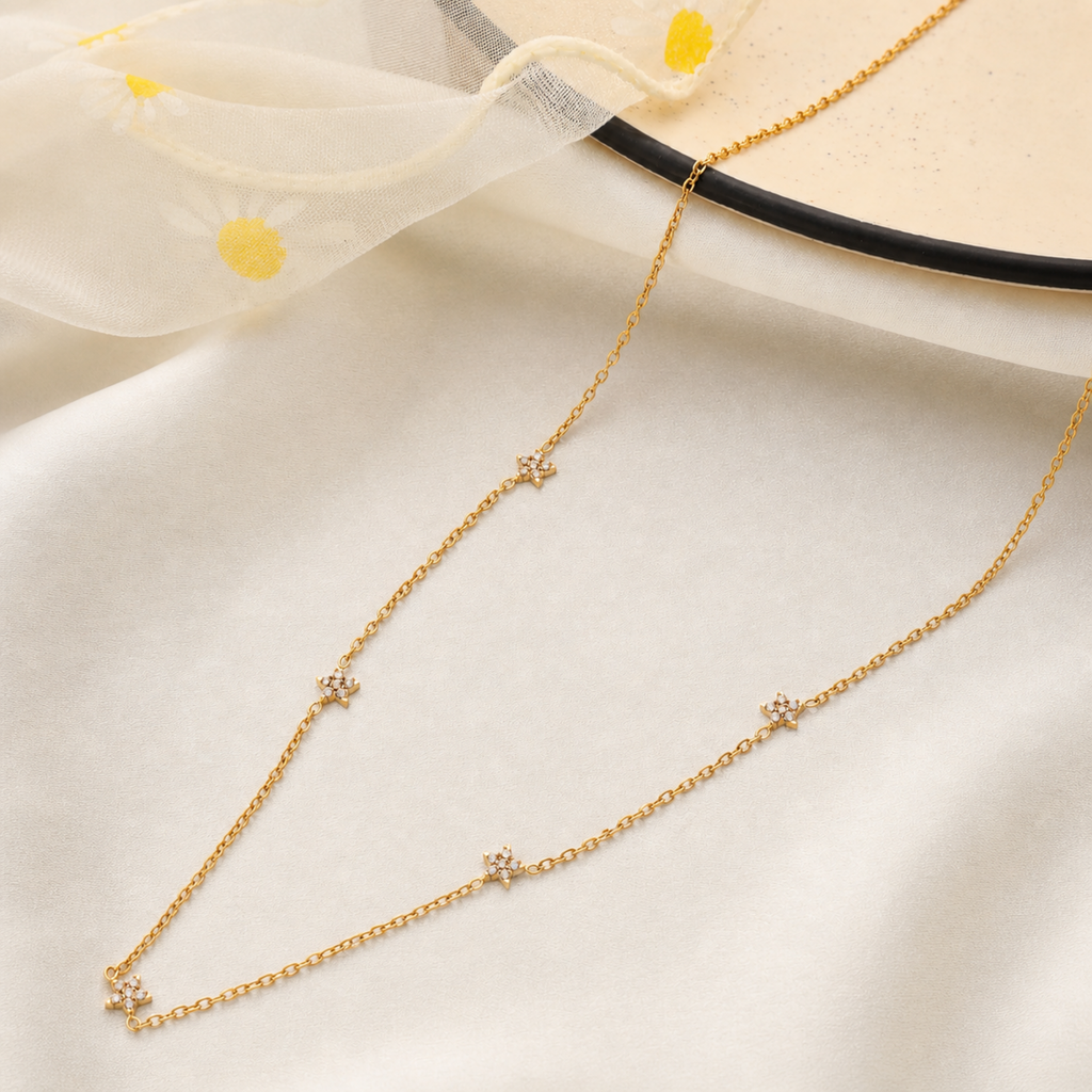 A gold-plated stainless steel chain for women featuring multiple small crystal-encrusted star stations