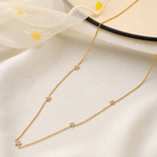 A gold-plated stainless steel chain for women featuring multiple small crystal-encrusted star stations