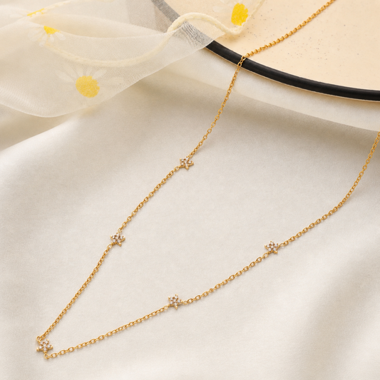 A gold-plated stainless steel chain for women featuring multiple small crystal-encrusted star stations
