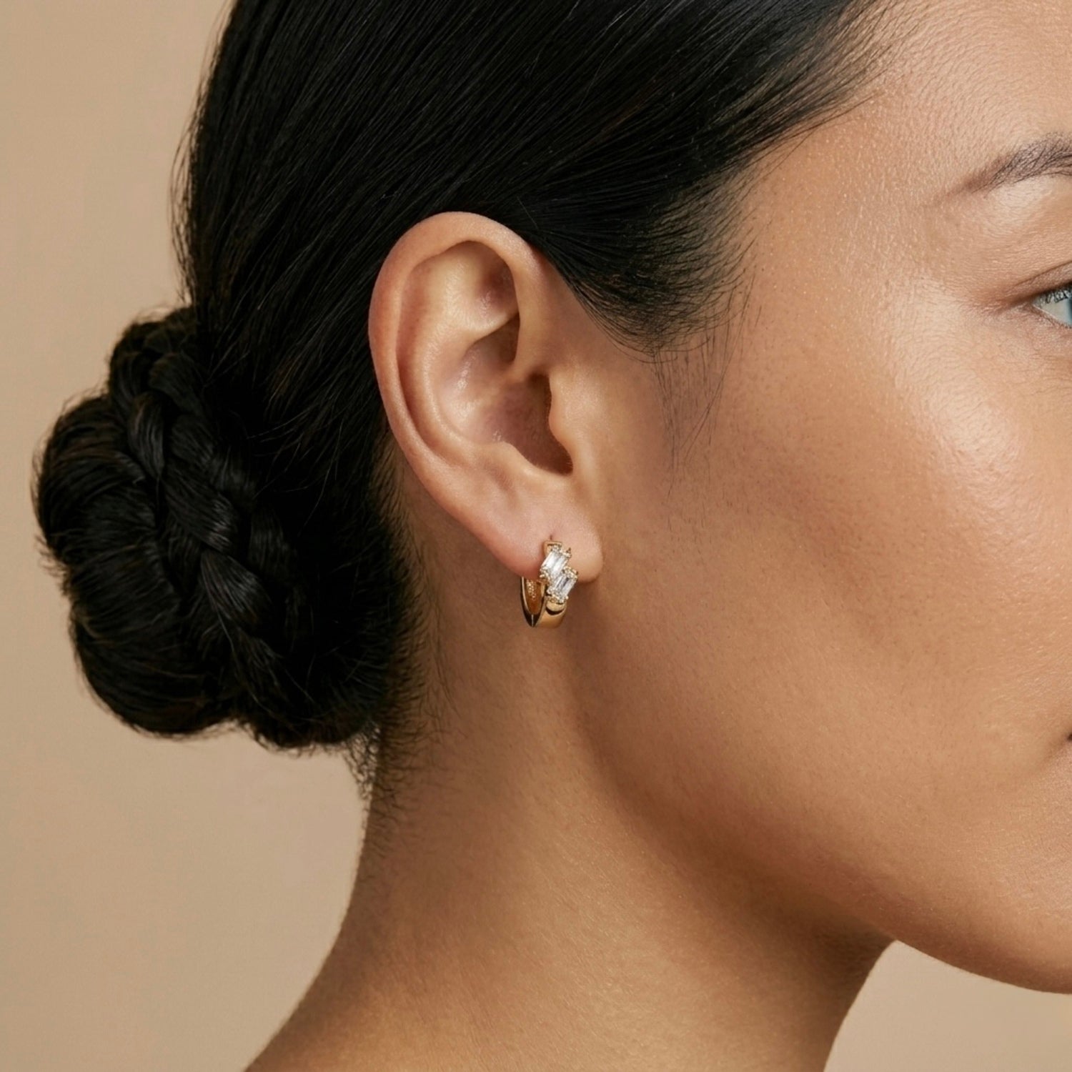 A gold-plated double-row crystal huggie hoop earrings for women shown on a model