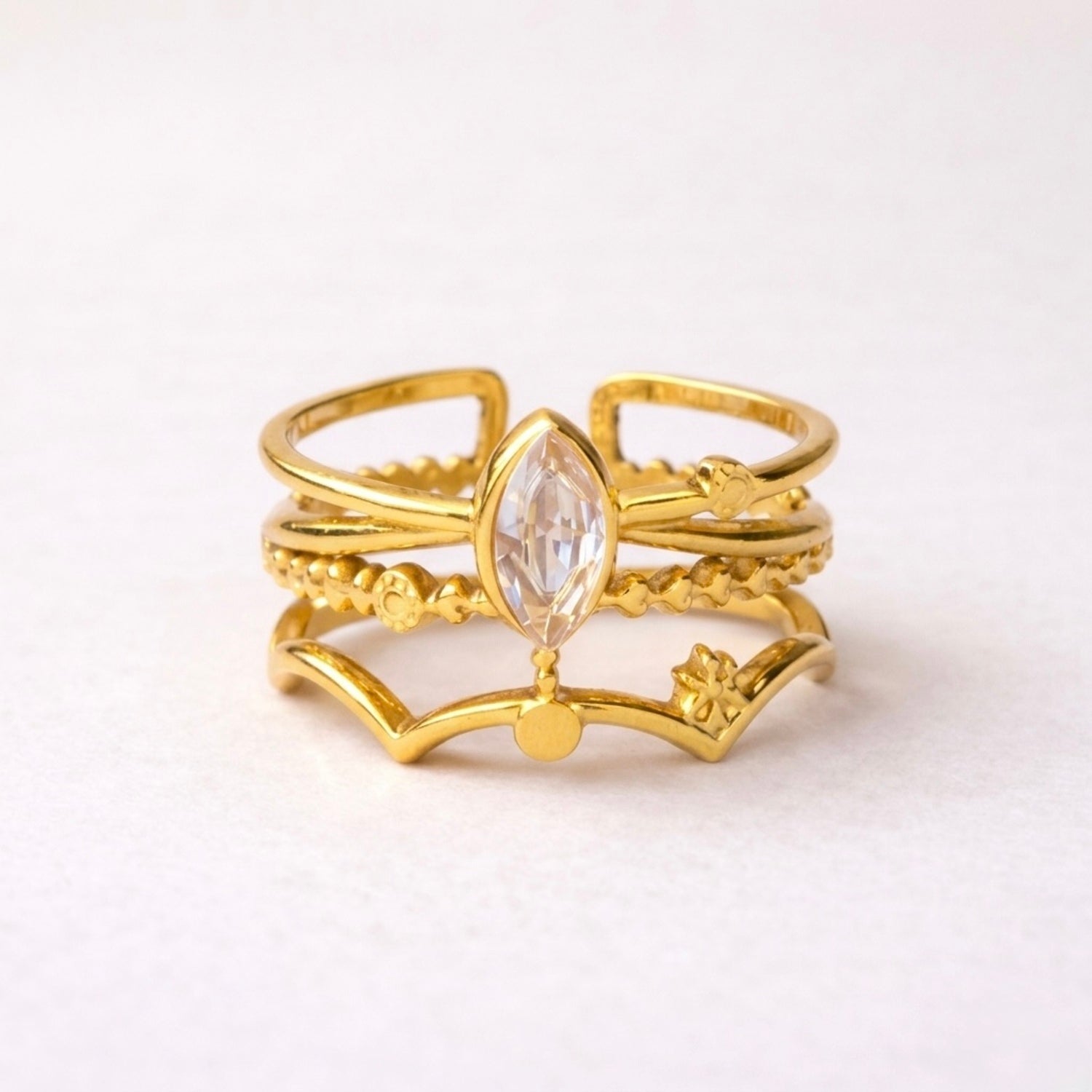 A triple-layered gold plated adjustable ring band for women on a white background