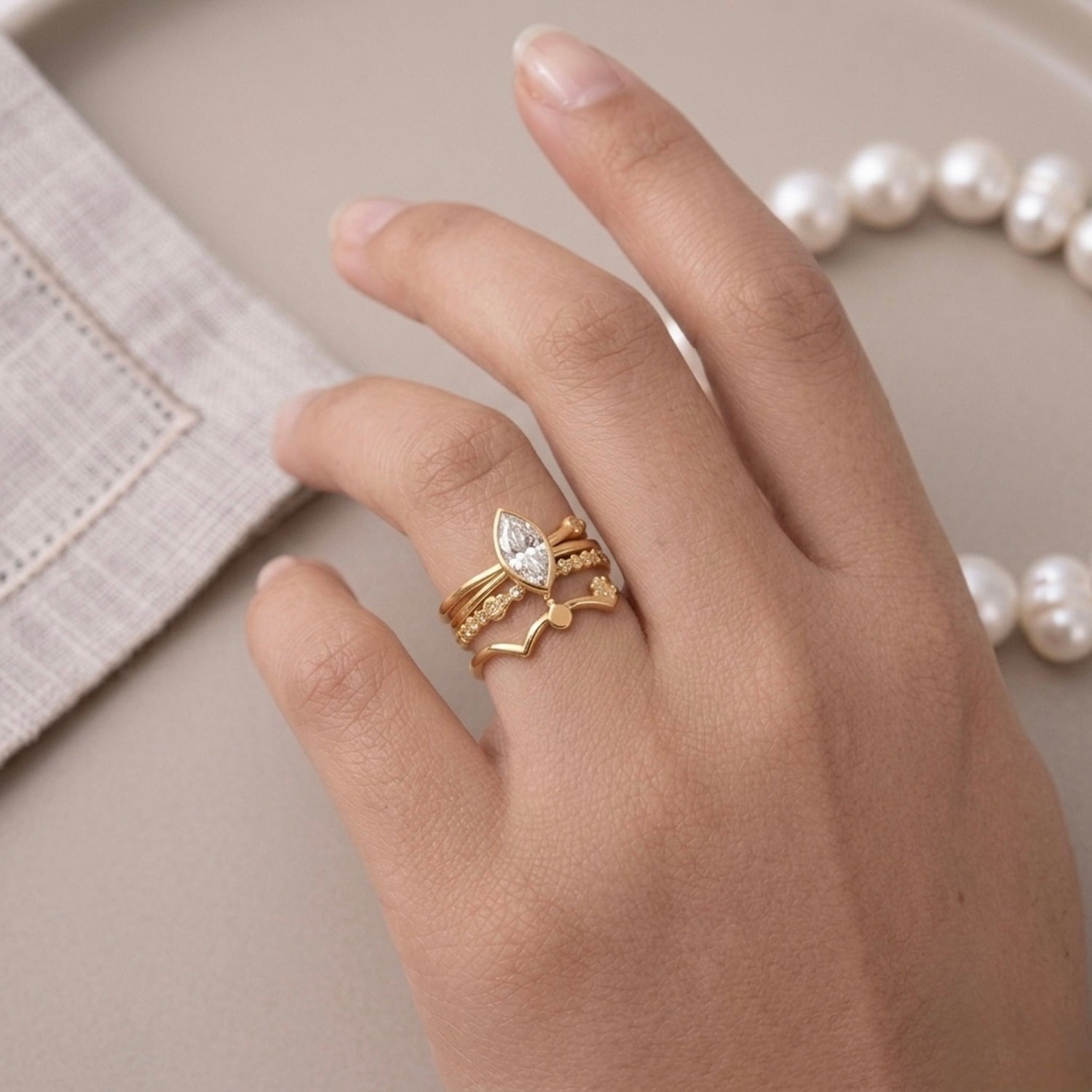 A triple-layered gold plated adjustable ring band for women on a model hand