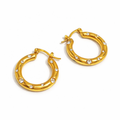 A pair of gold-plated thick hoop earrings for women featuring scattered clear crystals, shown on a white background